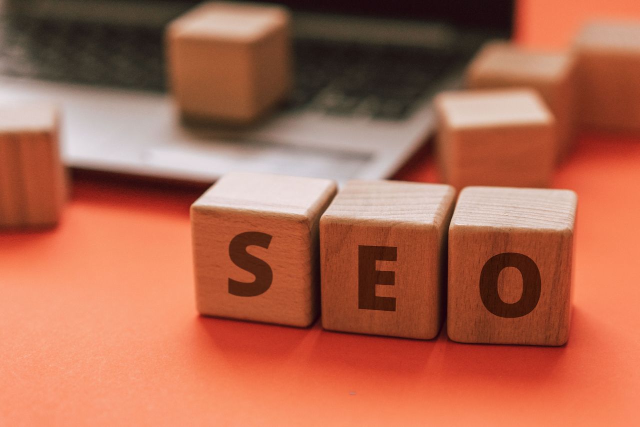 services-01 Wooden blocks spelling SEO on a laptop keyboard convey digital marketing concepts.