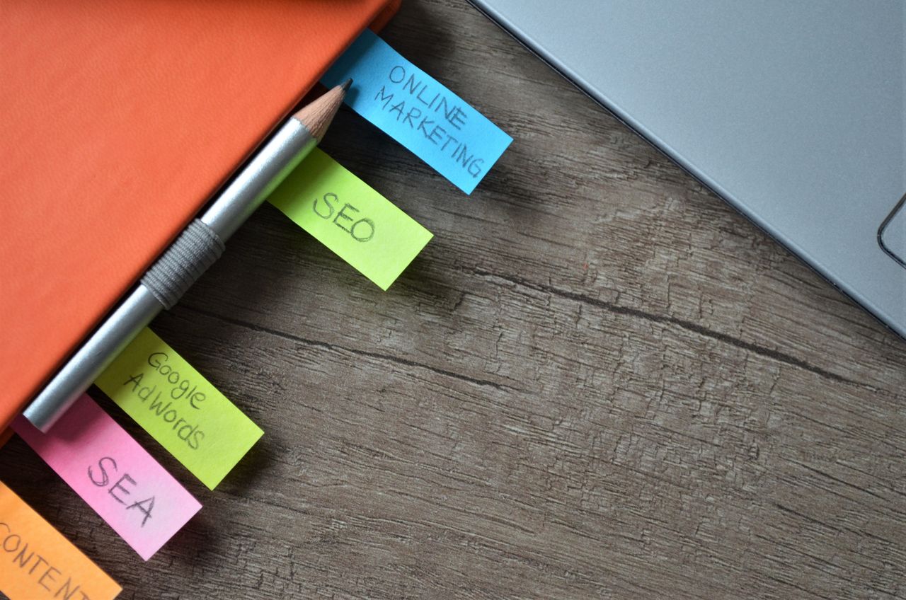 our-story Close-up of SEO strategy planner with colorful sticky notes and a pencil on a notebook.
